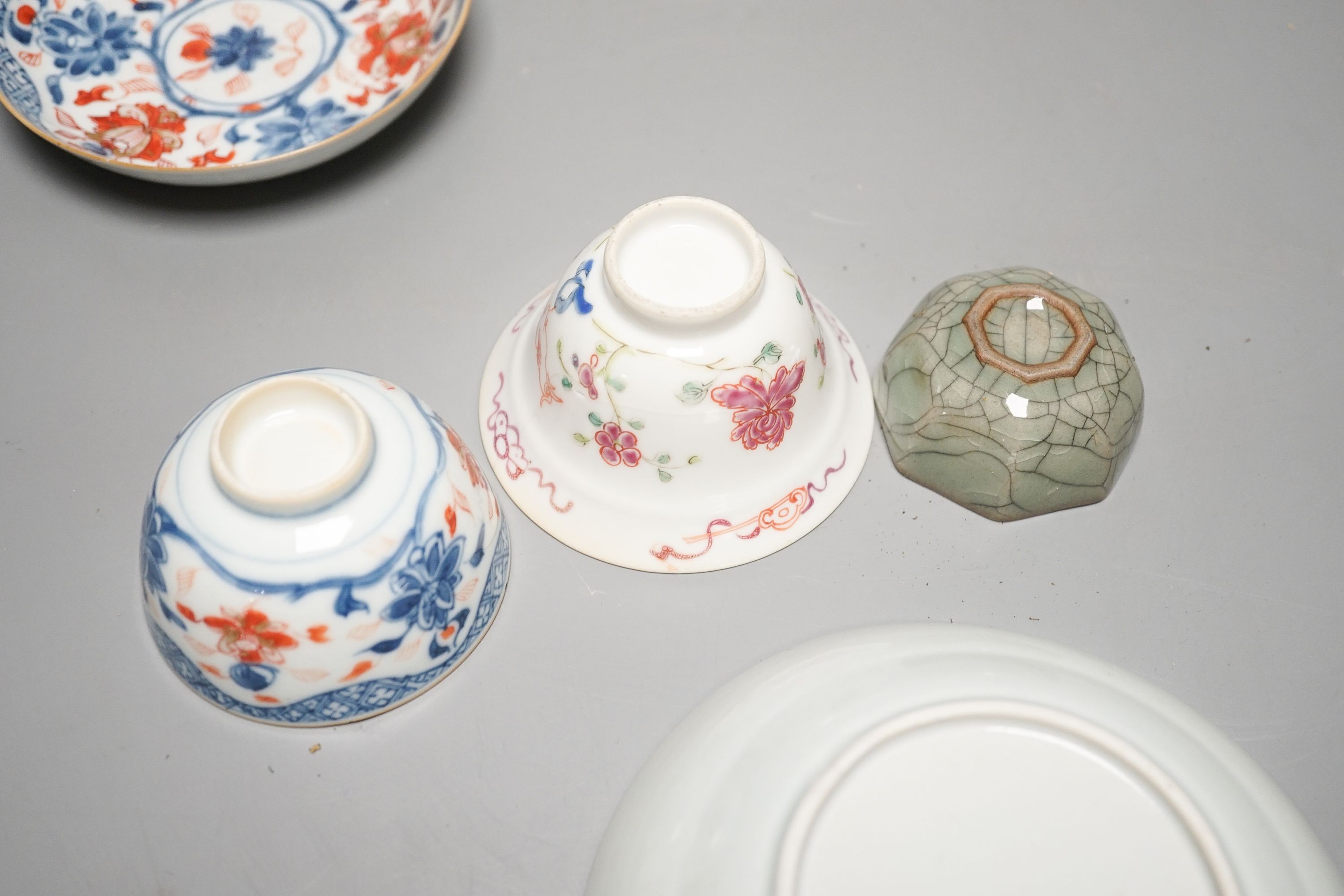 A Chinese Imari tea bowl and saucer, a famille rose tea bowl, a saucer and a celadon glazed cup